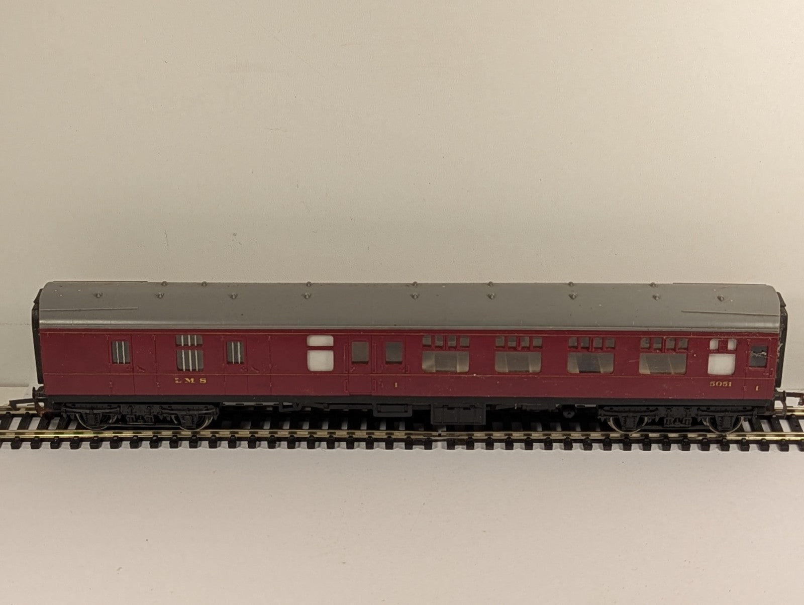Hornby OO gauge LMS brake third passenger coach 5051 in crimson livery on model railway track