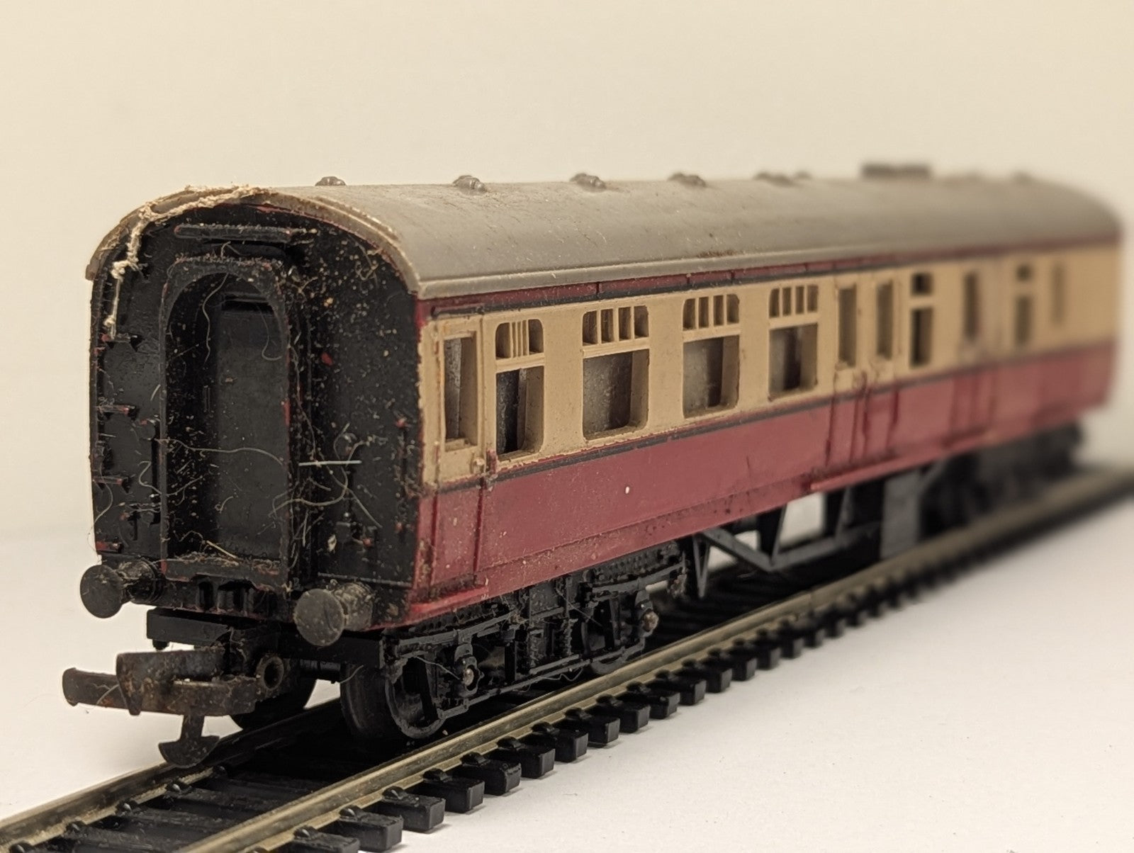 Tri-ang OO gauge BR crimson and cream composite passenger coach on model railway track