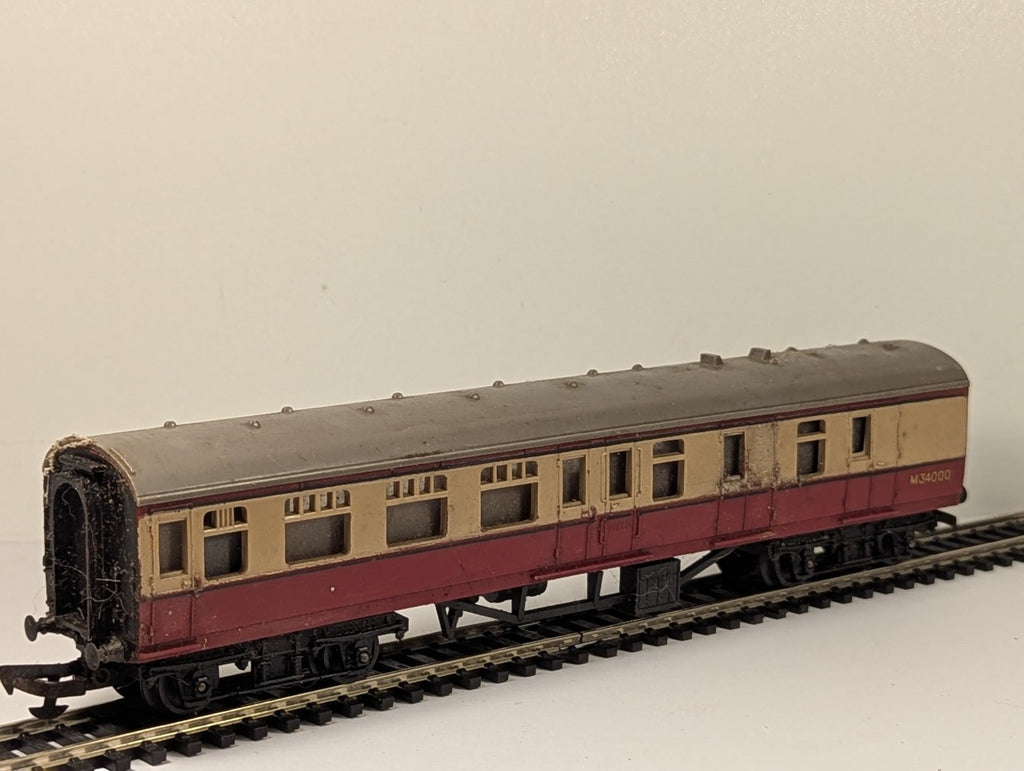 Tri-ang OO gauge BR crimson and cream composite passenger coach on model railway track