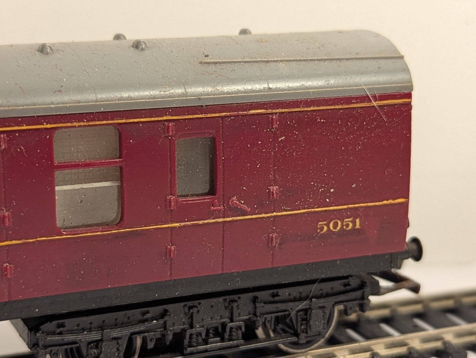 Hornby OO Gauge LMS Brake Third Coach 5051 in crimson livery on model railway track