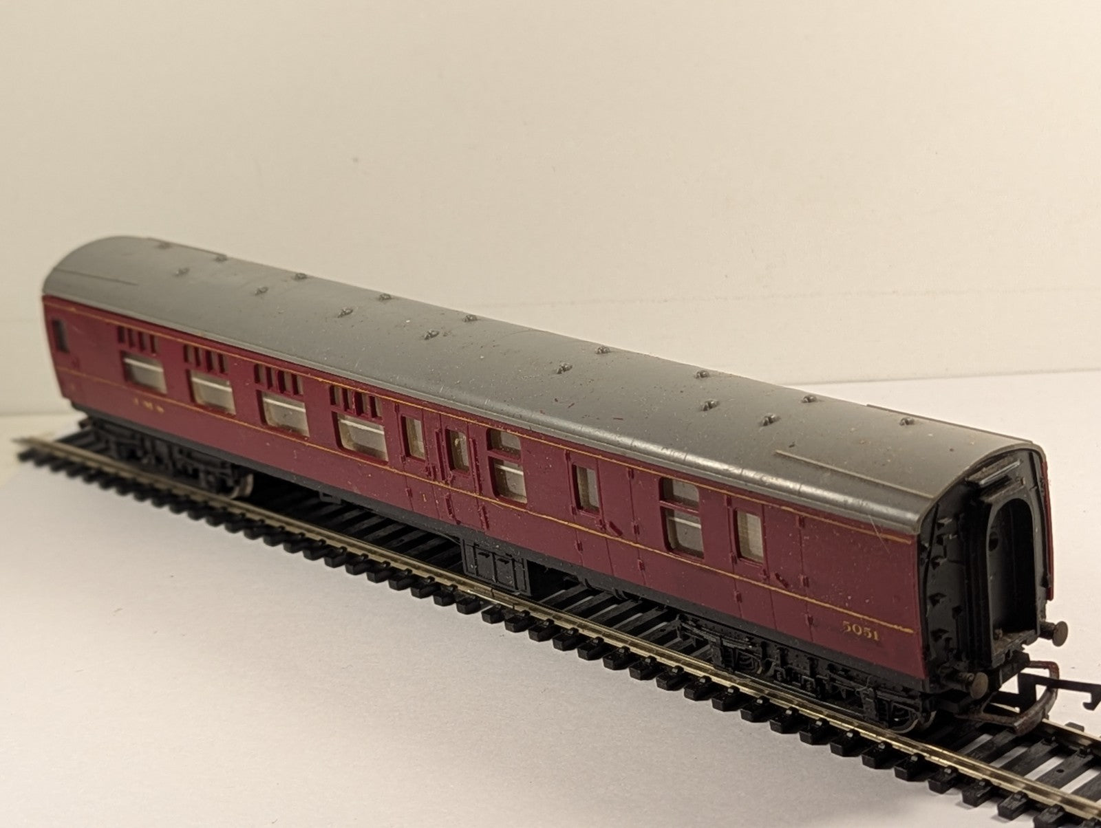 Hornby OO gauge LMS Brake Third passenger coach 5051 in crimson livery on model railway track