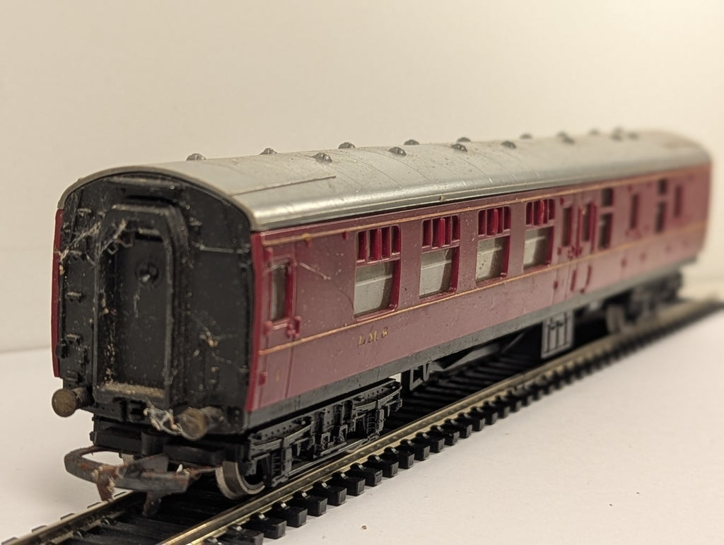 Hornby OO Gauge LMS Brake Third passenger coach in crimson livery on model railway track