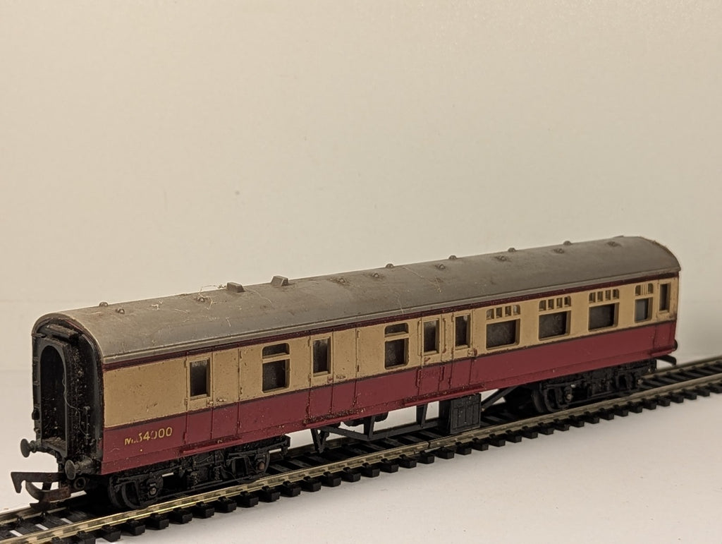 Tri-ang OO gauge BR crimson and cream composite passenger coach on model railway track