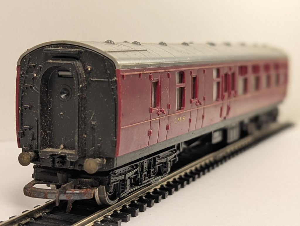 Hornby OO Gauge LMS Brake Third coach in crimson livery on model railway track