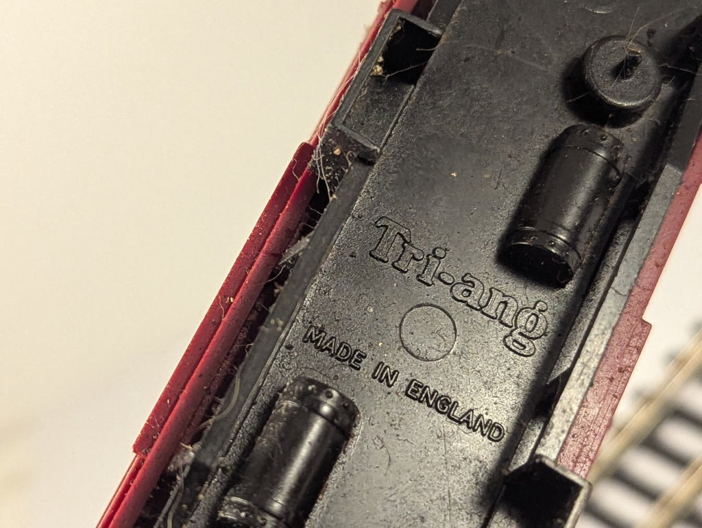 Underside of Tri-ang OO Gauge BR Crimson and Cream Composite Coach showing molded brand name and Made in England text