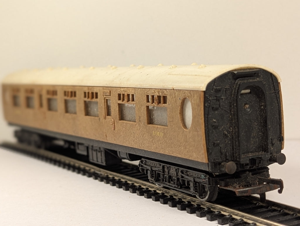 Tri-ang OO gauge LNER composite passenger coach 1010 with teak finish on model railway track