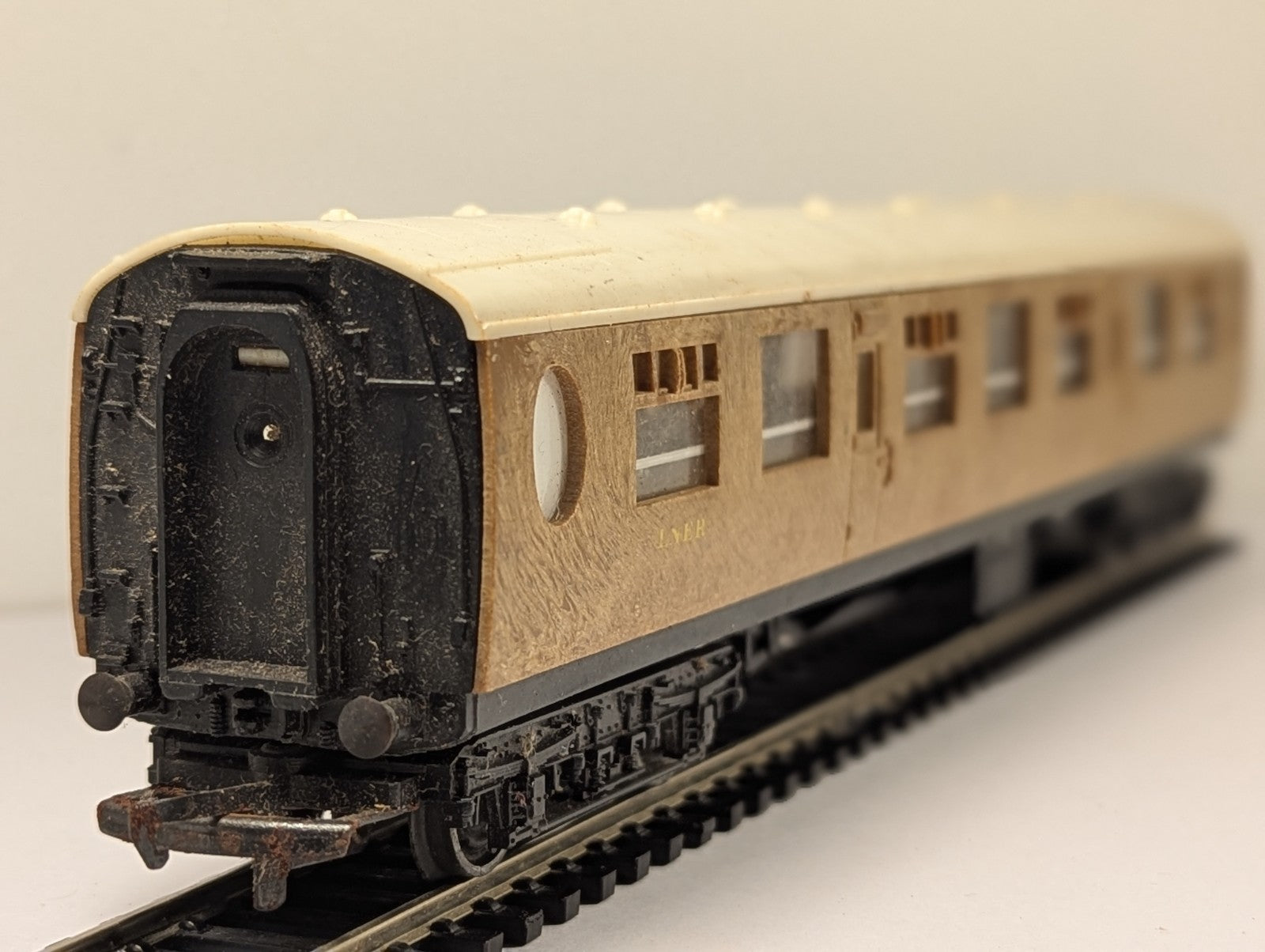 Tri-ang OO gauge LNER composite passenger coach in teak finish on model railway track