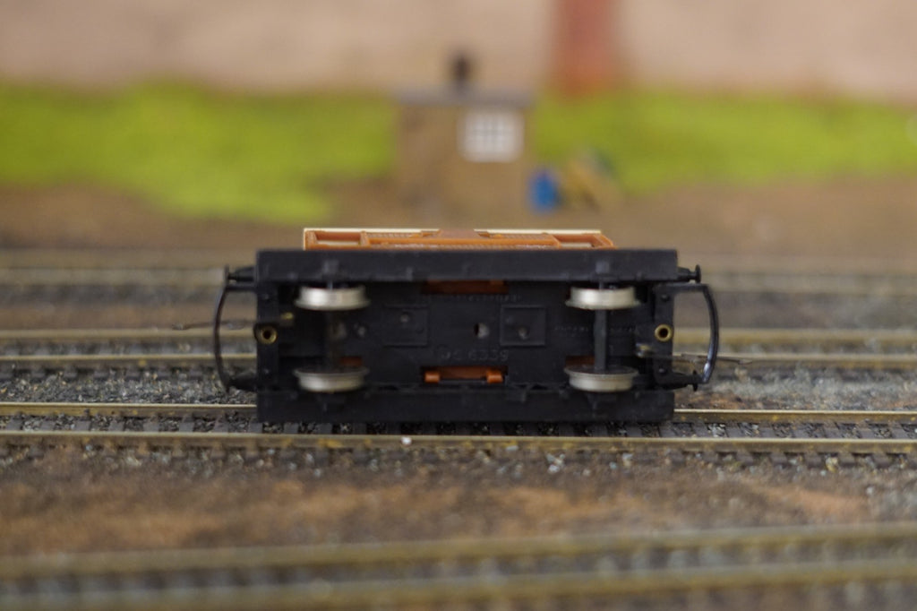 Underside view of a Hornby OO Gauge BR Brown 20 Ton Brake Van on model railway tracks